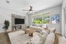 On the other side of the breakfast bar is this spacious family room that over looks the pool in the back yard (photo virtually staged).