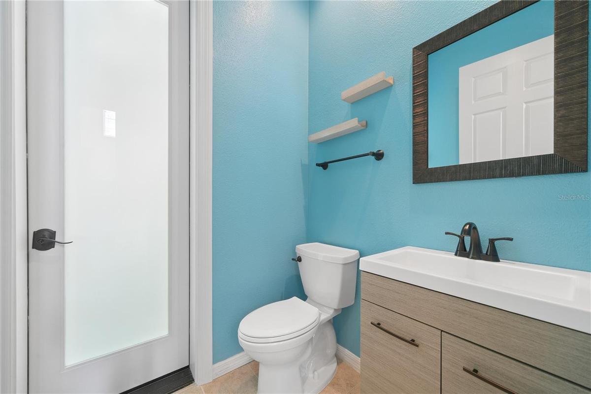 In this area is a convenient 1/2 bath that will also take you out to the pool area.