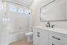 The ensuite for bedroom 2 with it's own linen closet (not shown) and a full 4 piece ensemble.