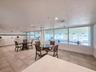 Community room with kitchen and view of the indoor heated pool