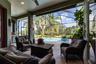 Covered lanai with fan overlooks pool and golf course