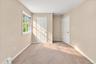 Bright, refreshed bedroom featuring brand-new carpeting and a fresh coat of paint, creating a clean and inviting space.