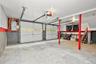 Multi-car garage featuring two white sectional doors, concrete flooring, and overhead door openers