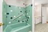 Conveniently designed bathroom with access from both the primary bedroom and hallway, featuring a separate tub area for added functionality and privac