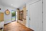 Entryway featuring wood-finish flooring, floor-to-ceiling custom built-in cabinetry, recessed lighting, and a glass-paneled exterior door