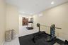 Large-format tile flooring, recessed ceiling lighting, and a prominent wood-panel feature wall