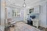 Tray ceiling, built-in cabinetry with beadboard paneling, recessed lighting, polished wood-finish flooring, and plantation shutters