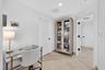 Neutral wall finishes, recessed lighting, and light-toned tile flooring