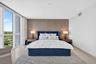 Floor-to-ceiling windows, light-toned tile flooring, textured accent wall, recessed lighting, and wall-mounted air conditioning vent