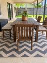 Outdoor dining space on the covered patio overlooking the pool deck