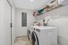 Full sized laundry room with private back entrance