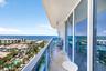 Balcony with glass railings and tile flooring