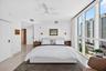 Floor-to-ceiling windows, modern ceiling fan, recessed lighting, and marble flooring