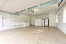 Multi-car garage featuring a concrete floor, integrated wall shelving, built-in cabinetry, and overhead lighting