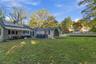 Back yard with stone patio and retractable awning