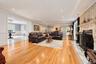 Living area featuring wood-finish flooring, an ornate fireplace mantel, stone hearth, recessed lighting, and crown molding
