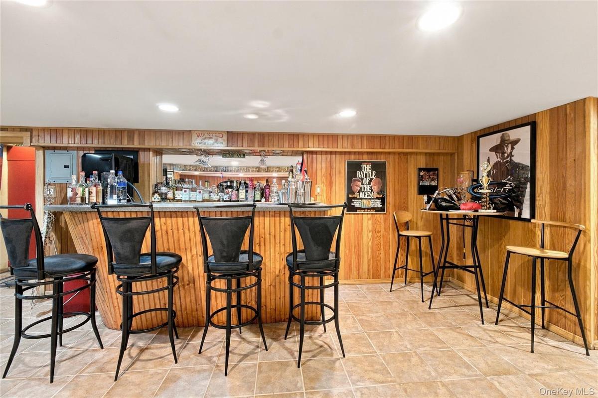 Wet bar in the basement with ceramic tile floors