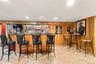 Wet bar in the basement with ceramic tile floors