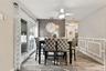Dining area with ceramic tile foor, wainscoting, sliders to patio and ceiling fan
