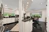 Kitchen featuring white cabinetry, dark stone countertops, stainless steel appliances, recessed lighting, and black tile flooring