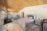 Bedroom with lofted ceiling, wooden ceiling, and light wood-style flooring