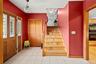 Foyer featuring stairs, a ceiling fan, and light tile patterned flooring