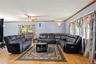 Living area featuring a ceiling fan, wood finished floors, and ornamental molding