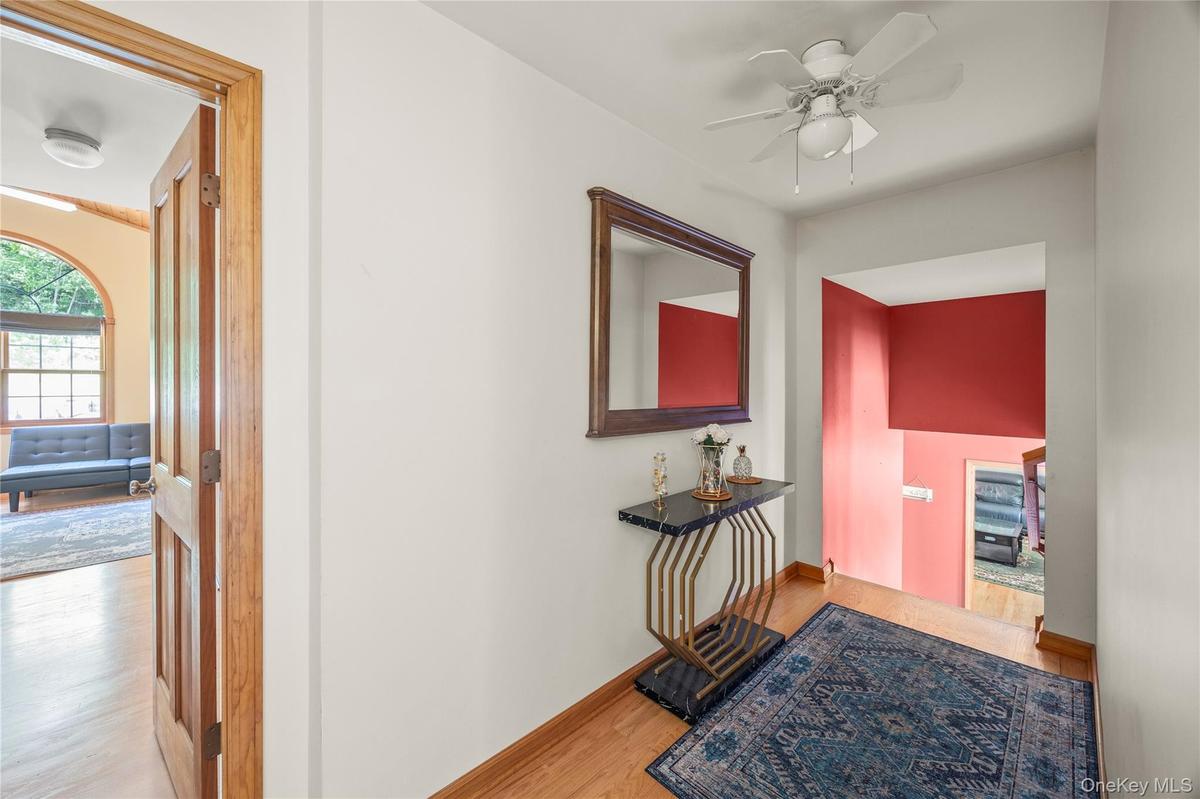 Hall with wood finished floors and baseboards