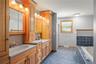 Full bathroom featuring vanity, a bath, and a shower stall