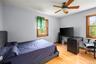 Bedroom featuring light wood-type flooring, a ceiling fan, and an office area