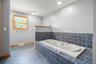 Full bath with a garden tub and tile patterned floors