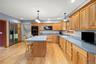 Kitchen featuring a breakfast bar area, light wood finished floors, backsplash, and recessed lighting
