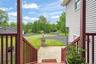 Wooden porch featuring a yard and driveway