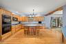 Kitchen featuring  center island, recessed lighting, light wood-type flooring, and backsplash