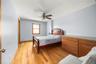 Bedroom with light wood-type flooring and ceiling fan