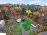 Autumn view from above of property with a heavily wooded area