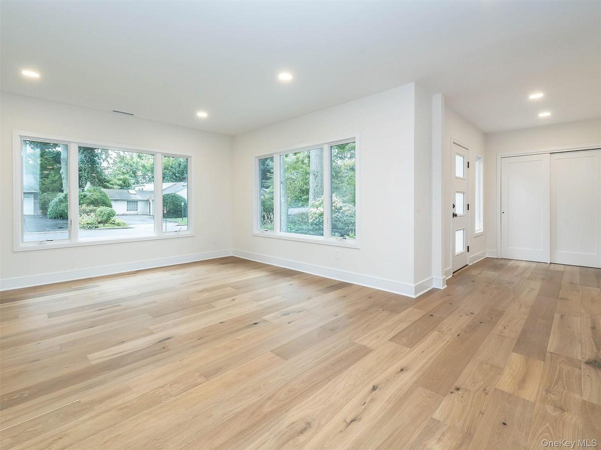 Entry leads into the bright living room. Photo to come of decorative brick fireplace