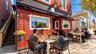 The Tavern Restaurant offers a variety of inviting dining spaces, including charming front patio seating, a welcoming indoor dining area, and an incre