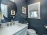 Half bath on first floor off of the family room/ den