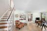Living room at entrance and stairs to bedrooms