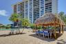 Outdoor tiki hut dining space provides the perfect poolside spot to enjoy a meal in the shade.