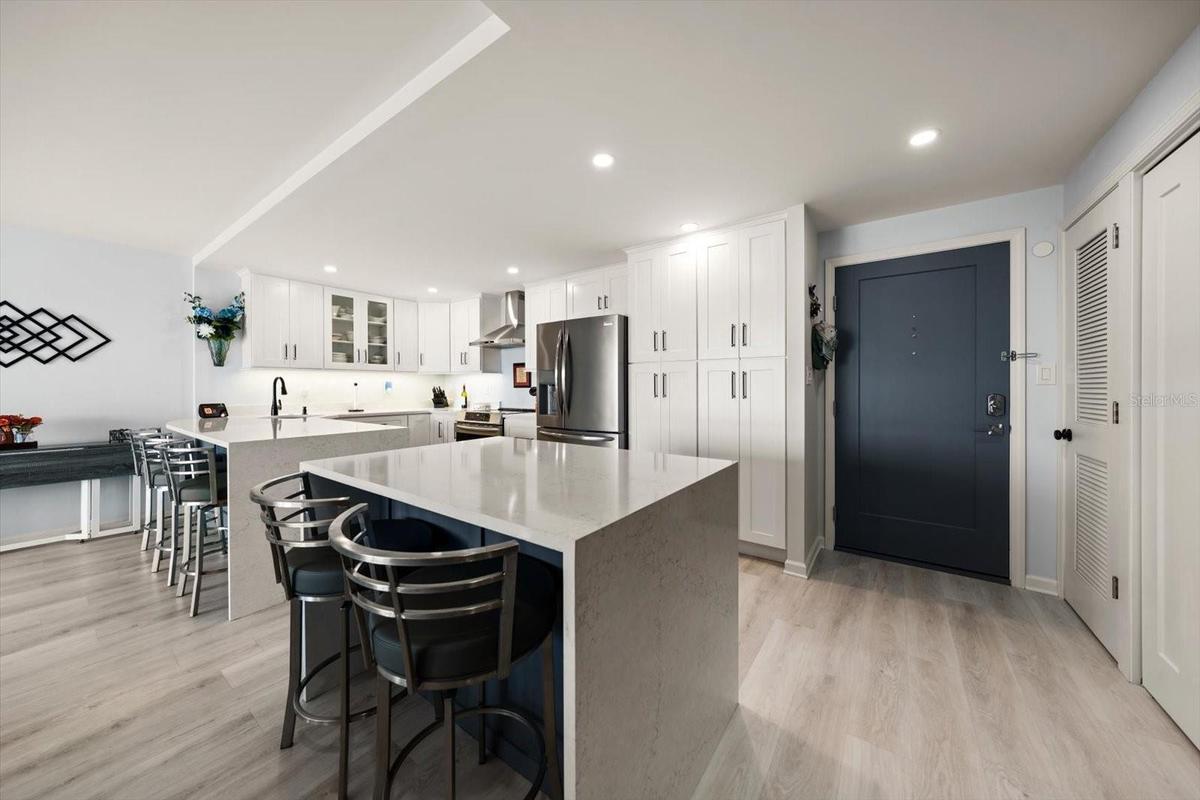 Additional kitchen island maximizes this space & provides additional dining or work space