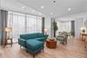 Living area featuring a wall of windows, recessed lighting, and light wood-style floors