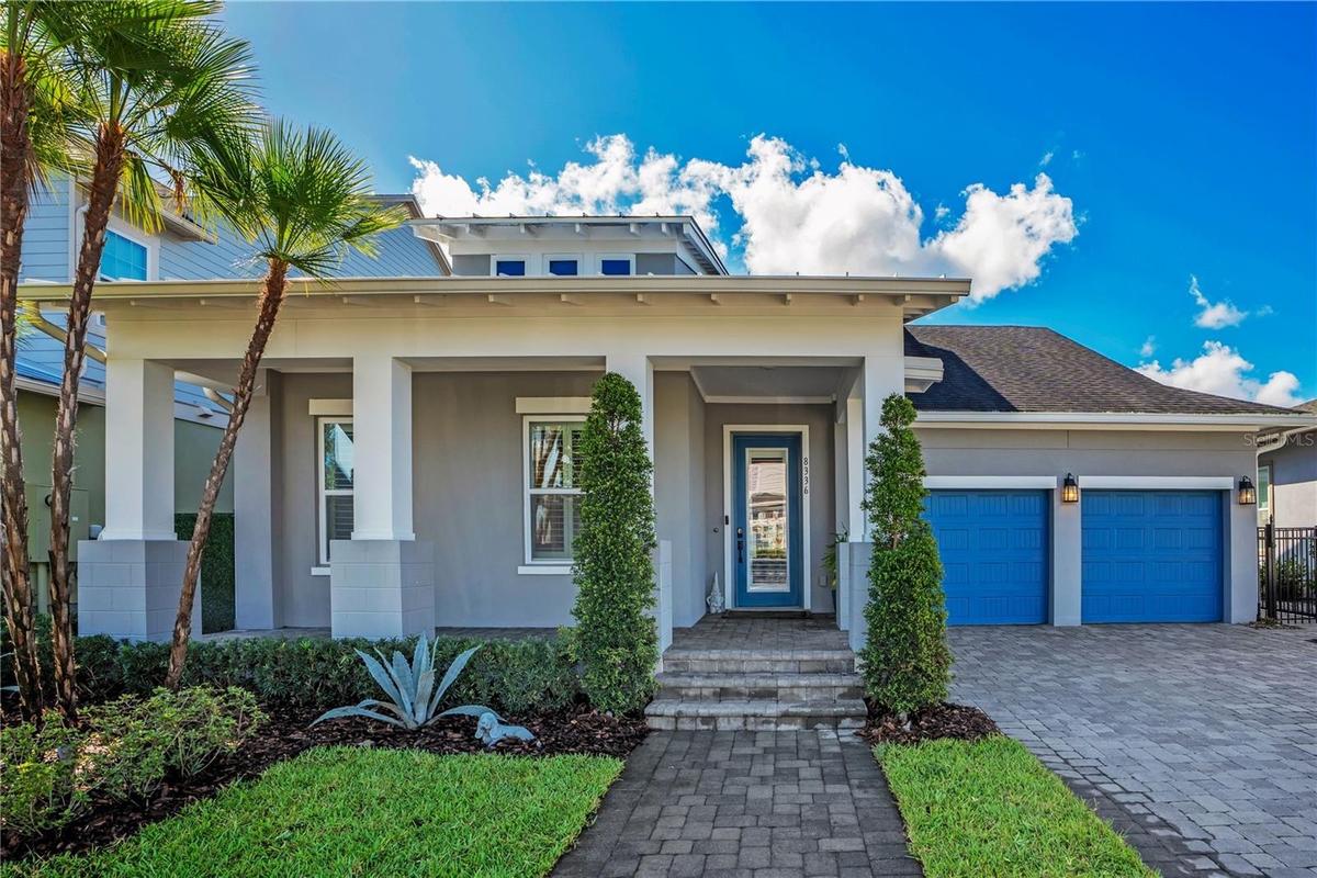 Welcome to 8336 Canetti St in Laureate Park, Lake Nona, Orlando FL 32827. A 2020 David Weekley Shalimar with contemporary curb appeal, lush palms, and