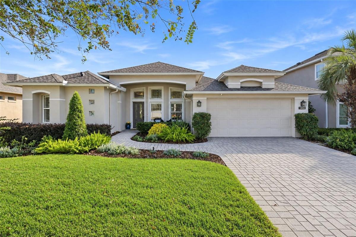 FRONT OF THE HOUSE WITH PAVER DRIVEWAY, SIDEWALK AND FRONT PATIO