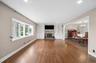 Living room with picture window and built-ins surrounding a wood burning fireplace.