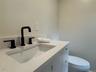 primary suite bathroom with custom designed shower