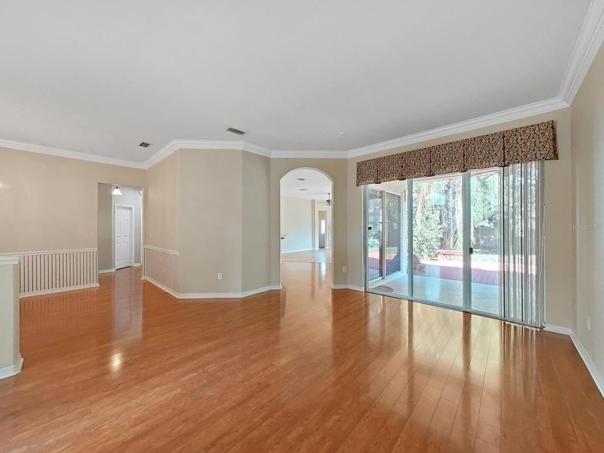 View from Living Room into Kitchen/Family Room and Doors to Lanai