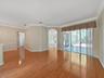 View from Living Room into Kitchen/Family Room and Doors to Lanai