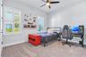 Secondary bedroom with room for a desk, ceiling fan, and plenty of natural light.